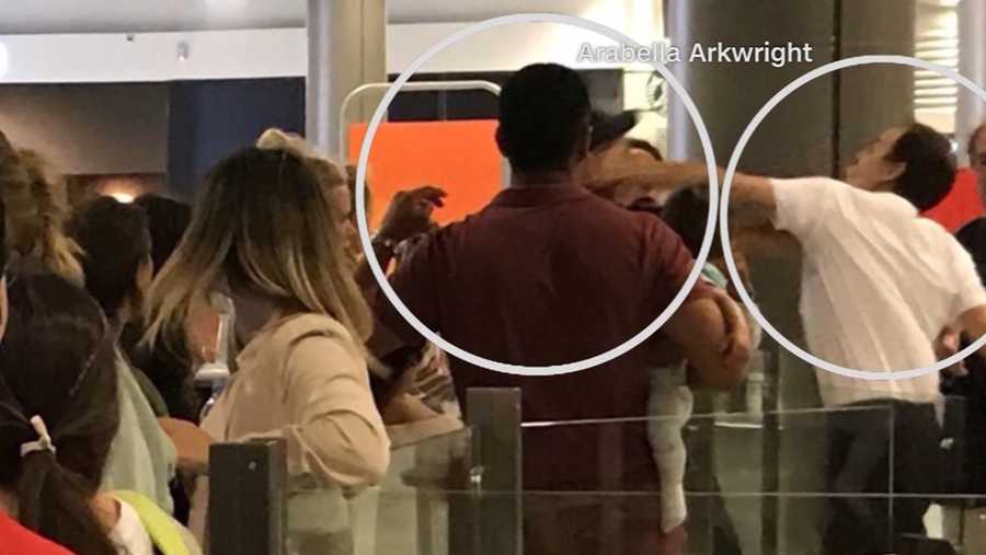 Airport worker punches passenger holding a baby