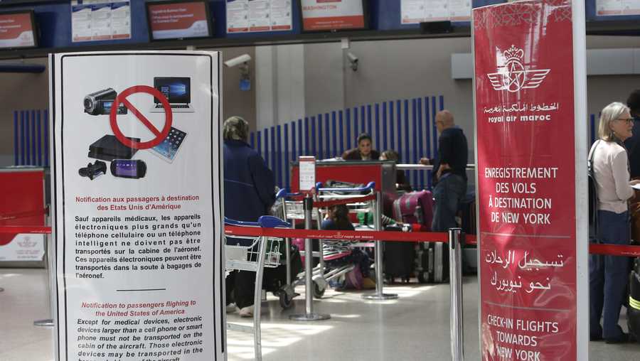 Placards inform passengers at the entrance to the Casablanca - New York flight checkpoint at Casablanca Mohammed V International Airport on Thursday, March 29, 2017.