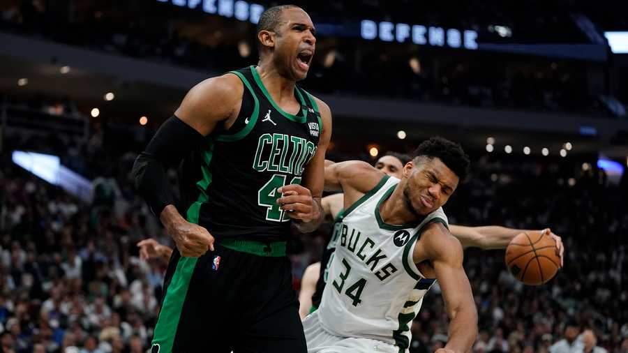 Boston Celtics' Al Horford reacts in front of Milwaukee Bucks' Giannis Antetokounmpo during the second half of Game 4 of an NBA basketball Eastern Conference semifinals playoff series Monday, May 9, 2022, in Milwaukee. The Celtics won 116-108 to tie the series 2-2.