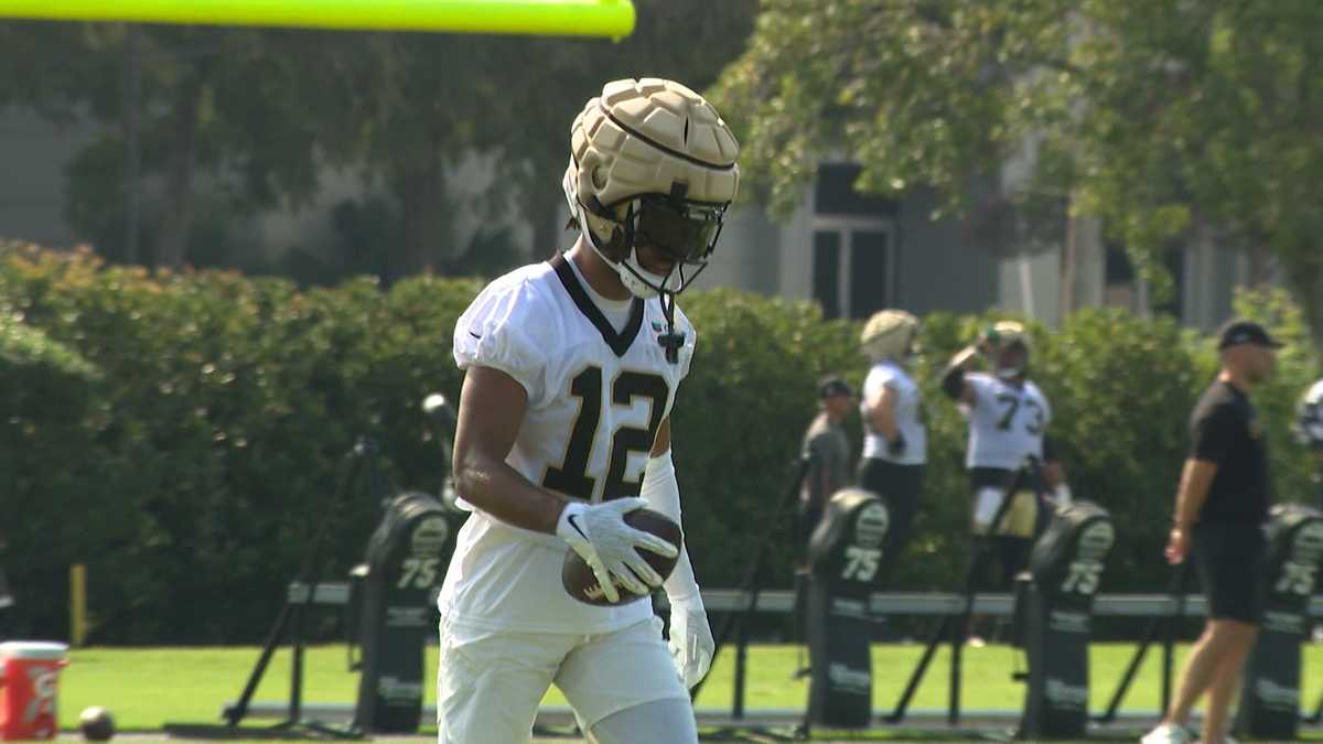 New Orleans Saints wide receiver Chris Olave wears his helmet