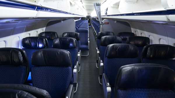 American Airlines is dropping its first class cabins for more business class seats. Pictured are first and economy class cabins of an American Airlines aircraft at Dallas/Fort Worth International Airport on September 1, 2019.