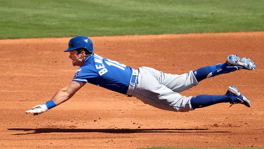 TEMPE, ARIZONA - MARCH 24: Andrew Benintendi #16 of the Kansas City Royals dives to safely reach second base in the third inning against the Los Angeles Angels during the MLB spring training game at Tempe Diablo Stadium on March 24, 2021 in Tempe, Arizona. (Photo by Abbie Parr/Getty Images)