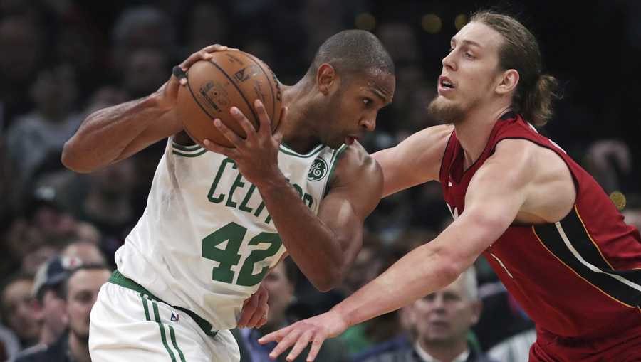 Boston Celtics center Al Horford (42) prepares to drive against Miami Heat forward Kelly Olynyk, right, during the second half of an NBA basketball game in Boston, Monday, April 1, 2019. (AP Photo/Charles Krupa)