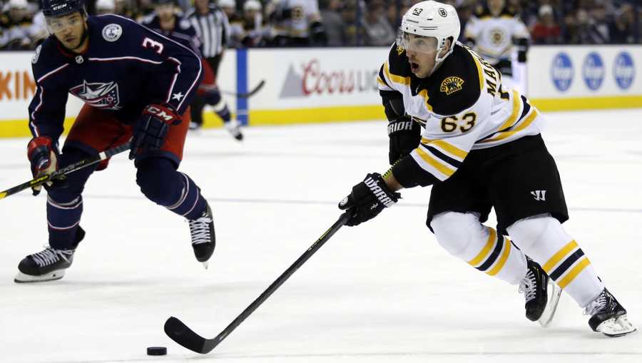 Boston Bruins forward Brad Marchand, right, controls the puck in front of Columbus Blue Jackets defenseman Seth Jones during the first period of an NHL hockey game in Columbus, Ohio, Tuesday, April 2, 2019. (AP Photo/Paul Vernon)