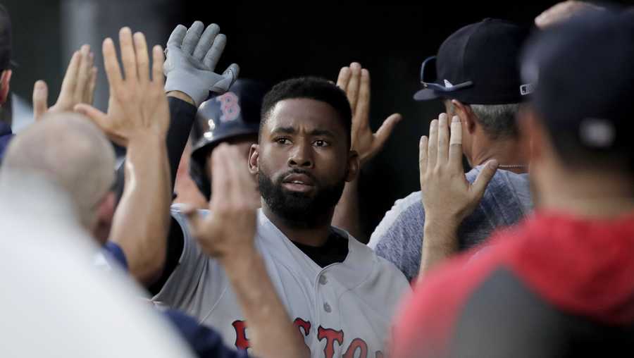 Boston Red Sox's Jackie Bradley Jr. is greeted in the dugout after hitting a three-run home run off Baltimore Orioles starting pitcher Thomas Eshelman during the second inning of a baseball game, Saturday, July 20, 2019, in Baltimore. (AP Photo/Julio Cortez)