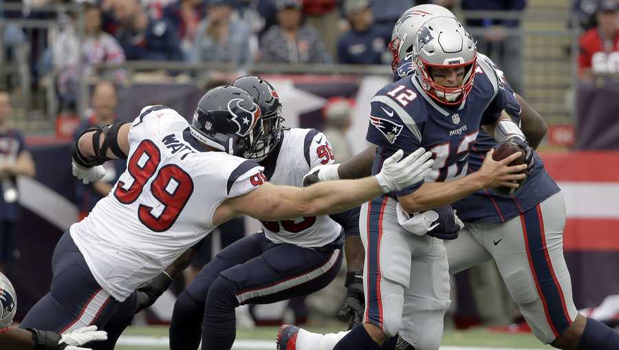 In this Sunday, Sept. 9, 2018, file photo, Houston Texans defensive end J.J. Watt (99) tries to pull down New England Patriots quarterback Tom Brady (12) during the second half of an NFL football game in Foxborough, Mass. Watt got better as the day went on his first game since breaking his leg last October. After getting through that game, the three-time Defensive Player of the Year is looking to make more of an impact this week when the Texans visit Tennessee. (AP Photo/Steven Senne, File)