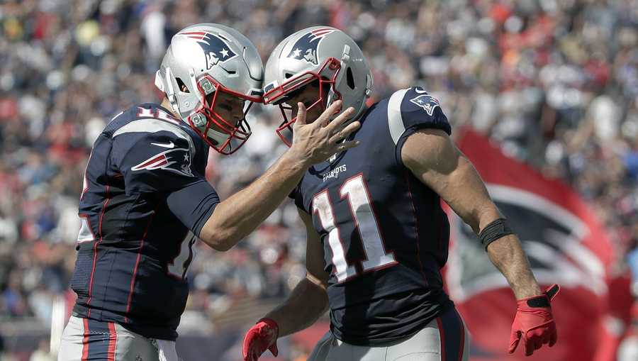 New England Patriots quarterback Tom Brady, right, celebrates a