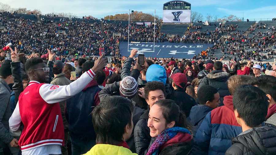 Demonstrators stage a protest on the field at the Yale Bowl disrupting the start of the second half of an NCAA college football game between Harvard and Yale, Saturday, Nov. 23, 2019, in in New Haven, Conn. (AP Photo/Jimmy Golen)