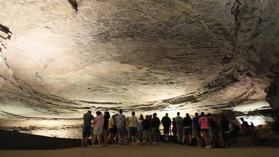 In this Wednesday, Aug. 3, 2011 photo, tour participants stand in the rotunda area of Mammoth Cave in Mammoth Cave National Park, Ky. Heading underground at Mammoth Cave National Park is a sure way to escape the summer heat. The celebrated cave that has lured the curious for thousands of years remains a temperate 54 degrees year-round.   (AP Photo/Ed Reinke)