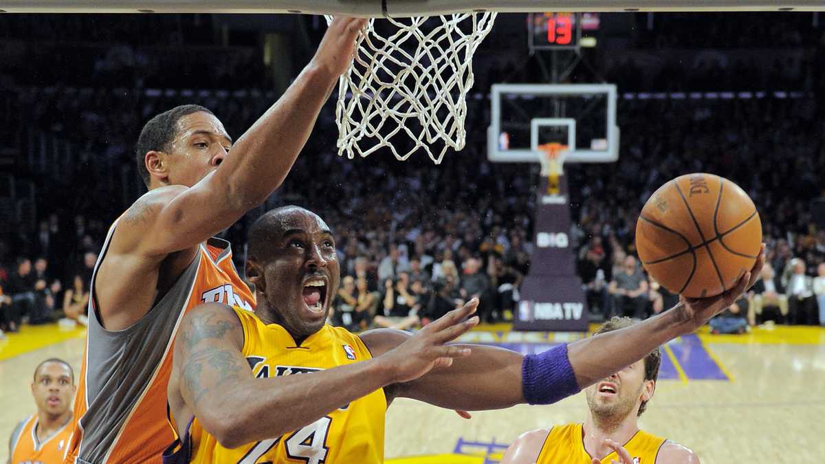 Orlando Magic's Dwight Howard (12) dunks over Los Angeles Lakers guard Kobe  Bryant (24) during the second half of Game 2 of the NBA basketball finals  Sunday, June 7, 2009, in Los