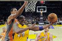 Los Angeles Lakers guard Kobe Bryant, right, puts up a shot as Phoenix Suns center Channing Frye during the second half of their NBA basketball game, Friday, Feb. 17, 2012, in Los Angeles. The Lakers won 111-99. (AP Photo/Mark J. Terrill)