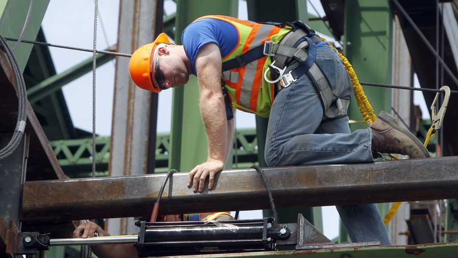 FILE - A worker checks a hydaulic jack on the Checkered House Bridge on Monday, June 18, 2012 in Richmond, Vt. 