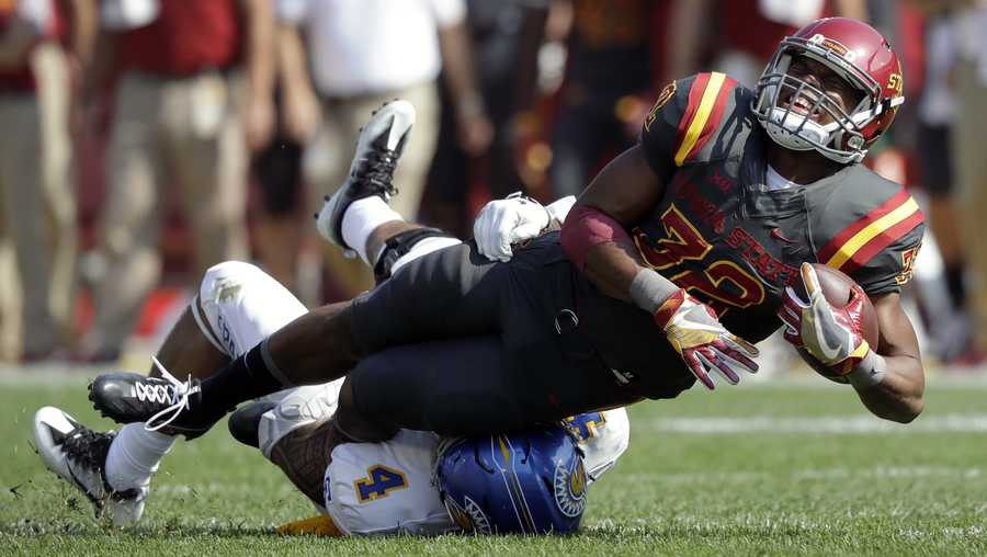 Iowa State running back David Montgomery runs over San Jose State linebacker Christian Tago (4) during the first half of an NCAA college football game, Saturday, Sept. 24, 2016, in Ames, Iowa. (AP Photo/Charlie Neibergall)