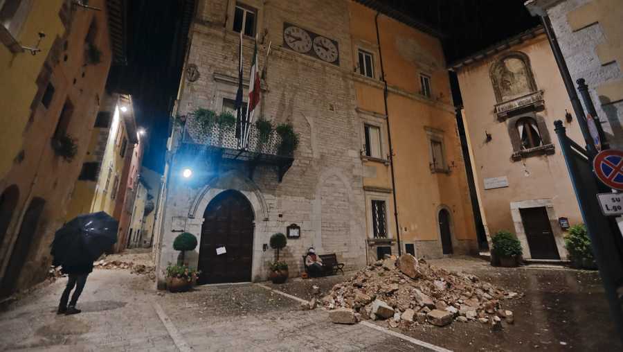 People wander around the small town of Visso in central Italy, early Thursday, Oct 27, 2016, after a 5.9 earthquake that destroyed part of their neighborhood. A pair of strong aftershocks shook central Italy late Wednesday, crumbling churches and buildings, knocking out power and sending panicked residents into the rain-drenched streets just two months after a powerful earthquake killed nearly 300 people.