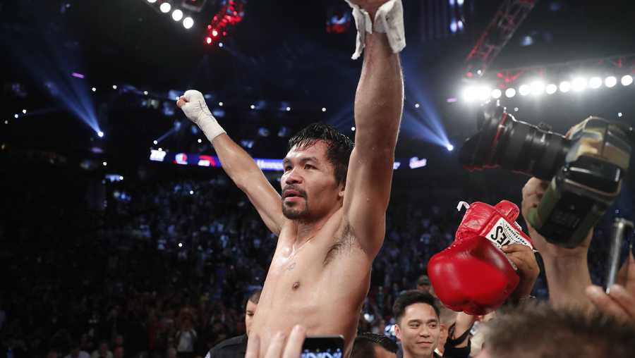 Manny Pacquiao, of the Philippines, celebrates after defeating Jessie Vargas in their WBO welterweight title boxing match Saturday.