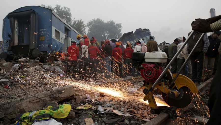 Rescuers search among the debris after 14 coaches of an overnight passenger train rolled off the track near Pukhrayan village in Kanpur Dehat district of the northern Indian state of Uttar Pradesh, India, Monday, Nov. 21, 2016. Dozens died and dozens more were injured in the accident.