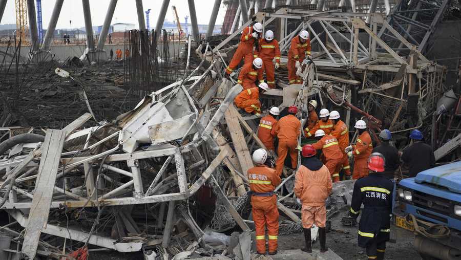 In this photo released by Xinhua News Agency, rescue workers look for survivors after a work platform collapsed at the Fengcheng power plant in eastern China's Jiangxi Province, Nov. 24, 2016. State media reported dozens were killed after the scaffolding tumbled down.