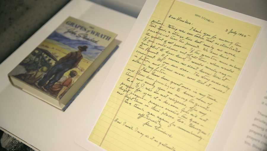 In this photo taken Thursday, May 11, 2017, is a letter from John Steinbeck and his book, "The Grapes of Wrath," in the exhibit "Dorothea Lange: Politics of Seeing," at the Oakland Museum of California in Oakland, Calif. The three major themes of the Lange display are the Great Depression, the home front during World War II and the urban decline and postwar sprawl in California. Running through August 13, the exhibit includes 100 of Lange's photographs, including recognized works as well as new, improved unframed prints that have been digitally scanned. (AP Photo/Eric Risberg)