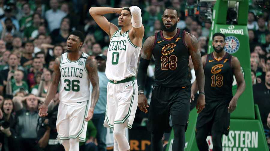 Boston Celtics guard Marcus Smart (36) and forward Jayson Tatum (0) react in front of Cleveland Cavaliers forward LeBron James during the second half in Game 7 of the NBA basketball Eastern Conference finals, Sunday, May 27, 2018, in Boston.
