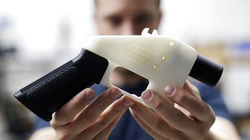 Cody Wilson, with Defense Distributed, holds a 3D-printed gun called the Liberator at his shop, Wednesday, Aug. 1, 2018, in Austin, Texas. 