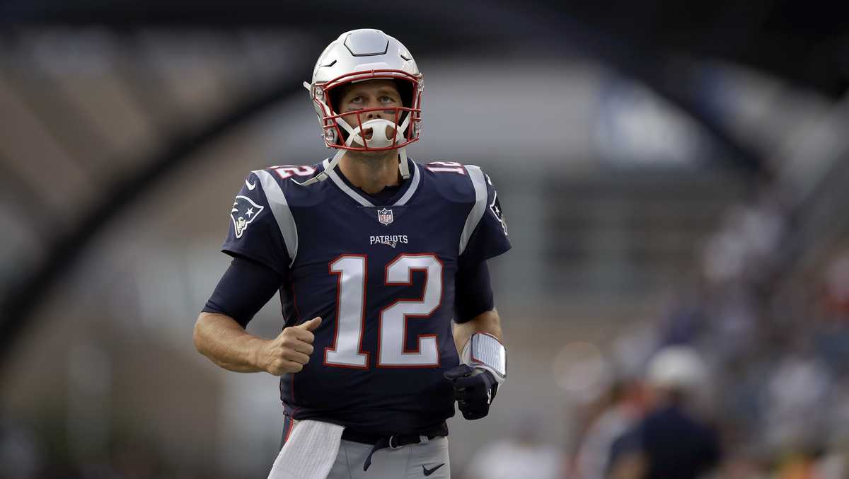 New England Patriots' Tom Brady (12) and Brian Hoyer (2) warm up before the  NFL Super