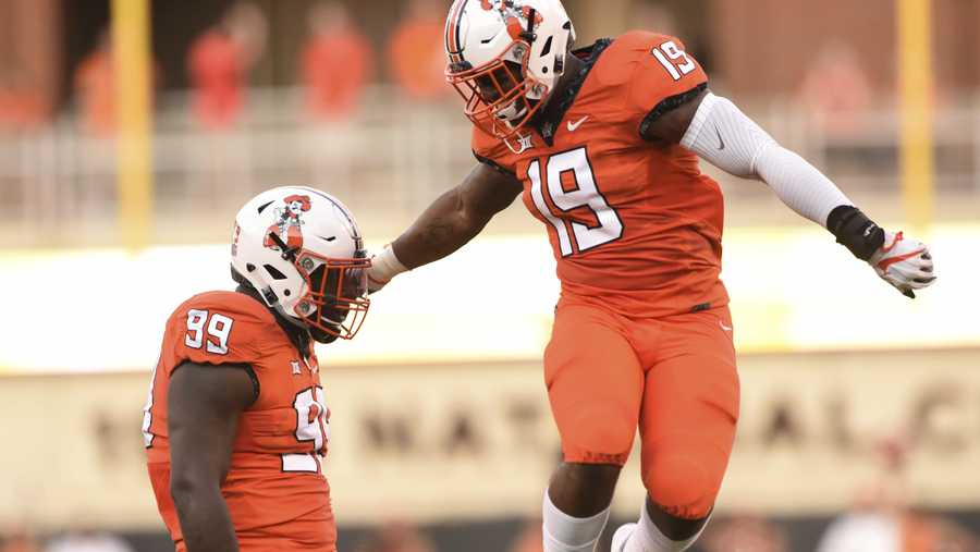 Oklahoma state linebacker Justin Phillips, right, celebrates with defensive tackle Trey Carter after a stop during the first quarter of an NCAA college football game against Missouri State in Stillwater, Okla., Thursday, Aug. 30, 2018. (AP Photo/Brody Schmidt)