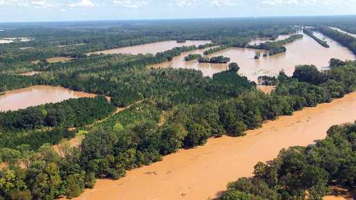 This Monday, Sept. 17, 2018, photo shows rising flood waters in the Pee Dee area in Marion County, S.C. Two female mental health patients detained for medical transport drowned Tuesday, Sept. 18, when a sheriff's department van was swept away in rising floodwaters, according to authorities. Officials said that the transport van was near the Little Pee Dee River, one of the bodies of water that state officials are watching following the heavy rains of Florence.