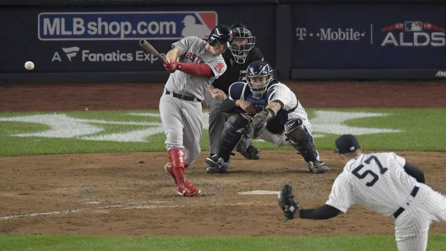 Boston Red Sox's Brock Holt connects for a two-run triple against the New York Yankees during the fourth inning of Game 3 of baseball's American League Division Series, Monday, Oct. 8, 2018, in New York. (AP Photo/Bill Kostroun)