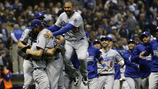 The Los Angeles Dodgers celebrate after Game 7 of the National League Championship Series baseball game Saturday, Oct. 20, 2018, in Milwaukee. The Dodgers won 5-1 to win the series.