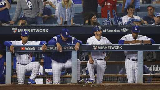 Los Angeles Dodgers manager Dave Roberts, left, watches the ninth inning in Game 4 of the World Series baseball game against the Boston Red Sox on Saturday, Oct. 27, 2018, in Los Angeles.