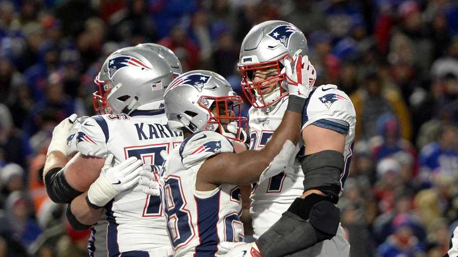 New England Patriots running back James White, center, celebrates his touchdown run with tight end Rob Gronkowski, right, during the second half of an NFL football game against the Buffalo Bills, Monday, Oct. 29, 2018, in Orchard Park, N.Y. (AP Photo/Adrian Kraus)