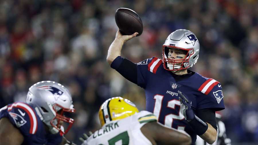 New England Patriots quarterback Tom Brady (12) passes under pressure from Green Bay Packers nose tackle Kenny Clark (97) during the first half of an NFL football game, Sunday, Nov. 4, 2018, in Foxborough, Mass. (AP Photo/Charles Krupa)