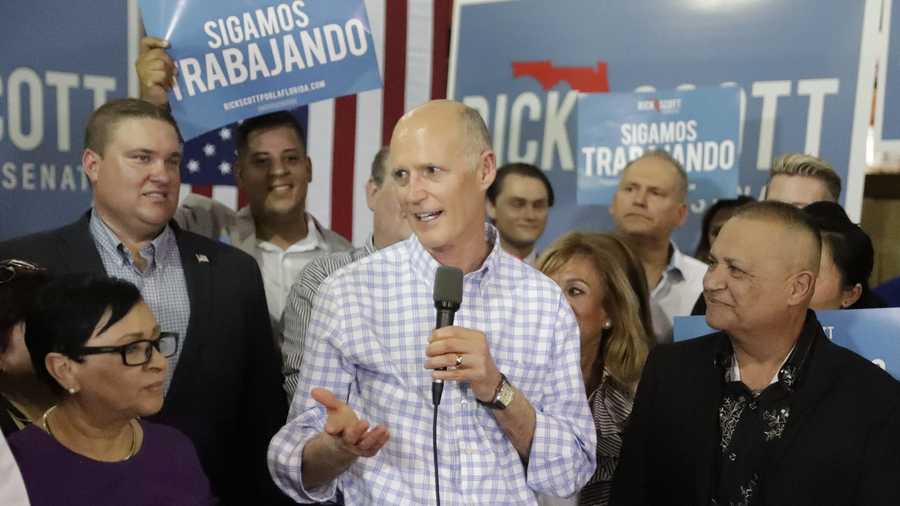 FILE- In this Sept. 18, 2018 file photo Florida Gov. Rick Scott, center, speaks at a campaign rally in Orlando, Fla. Scott is challenging three-term Democratic Sen. Bill Nelson. Florida will vote for governor, U.S. Senate, Cabinet seats, Congress and decide 12 ballot questions. (AP Photo/John Raoux, File)