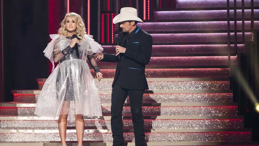 Hosts Carrie Underwood, left, wearing a bubblewrap dress, and Brad Paisley appear at the 52nd annual CMA Awards at Bridgestone Arena on Wednesday, Nov. 14, 2018, in Nashville, Tenn. (Photo by Charles Sykes/Invision/AP)