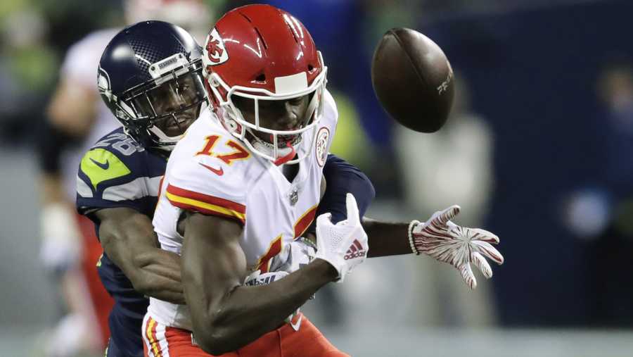 Kansas City Chiefs wide receiver Chris Conley (17) fumbles as he is tackled by Seattle Seahawks cornerback Justin Coleman, left, during the first half of an NFL football game, Sunday, Dec. 23, 2018, in Seattle. The Seahawks recovered the ball. (AP Photo/Stephen Brashear)