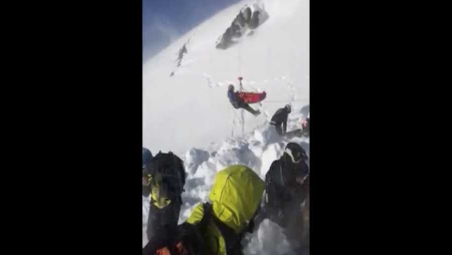 In this grab taken from validated UGC provided on Thursday, Dec. 27, 2018, a boy is airlifted after an avalanche, on the French Alps on Wednesday. A 12-year-old boy in the French Alps was found alive and uninjured after being buried under an avalanche for 40 minutes, an event his rescuers are calling a true "miracle." (UGC via AP)