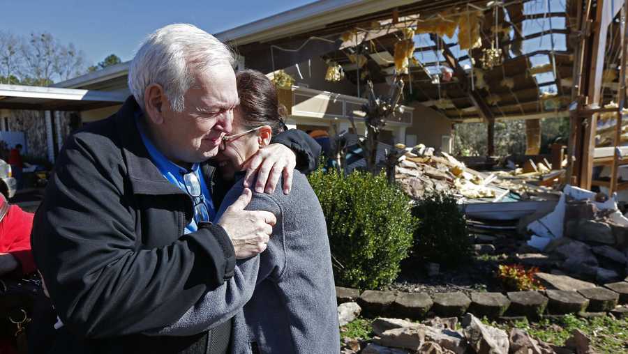 Pastor Steve Blaylock, left, comforts his wife Pat Blaylock, amid the rubble that was once the First Pentecostal Church in Columbus, Miss., Sunday morning, Feb. 24, 2019. A tornado Saturday wrecked havoc in the community, destroying a number of businesses as well as damaging and destroying homes.