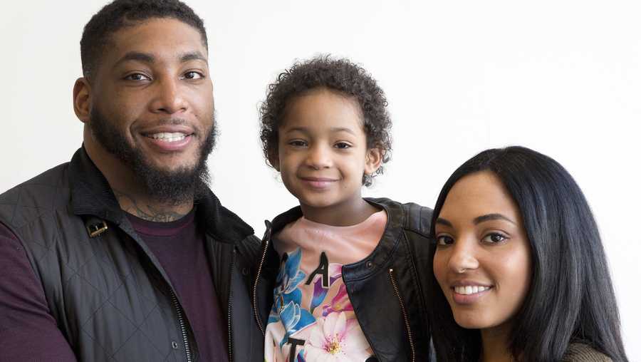 FILE - In this April 12, 2016, file photo, Devon Still and his fiancee, Asha Joyce, pose with their daughter, Leah, then 5, in New York. Leah was diagnosed in 2014 with cancer and became an inspiration to millions as her football-playing father shared details of her brave fight. She was given a prognosis of just over 50 percent to survive stage 4 neuroblastoma. Leah is now a healthy 8-year-old girl in third grade who lives in Houston. Devon Still has become an author, motivational speaker, and an inspiration--especially to strangers suffering like his family did. (AP Photo/Mark Lennihan, File)