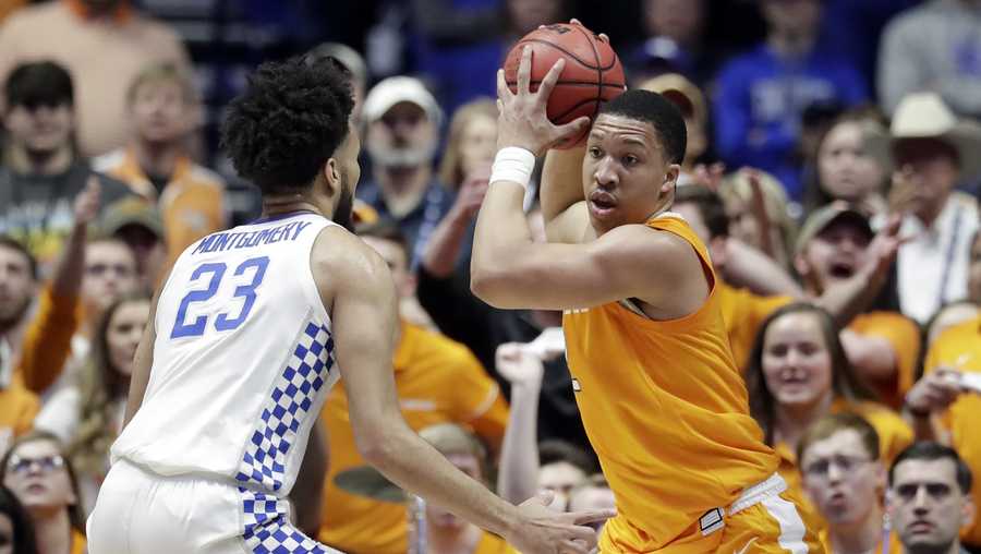 Tennessee's Grant Williams, right, protects the ball from Kentucky forward EJ Montgomery (23) in the first half of an NCAA college basketball game at the Southeastern Conference tournament Saturday, March 16, 2019, in Nashville, Tenn. (AP Photo/Mark Humphrey)