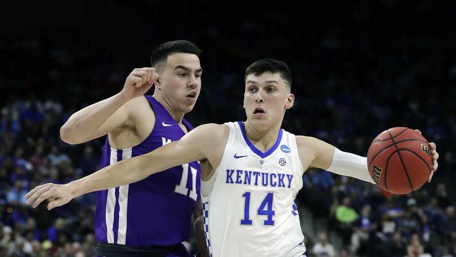 Kentucky's Tyler Herro (14) drives past Abilene Christian's Tobias Cameron (11) during the first half of a first-round game in the NCAA men’s college basketball tournament in Jacksonville, Fla. Thursday, March 21, 2019. (AP Photo/John Raoux)