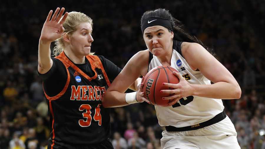 Iowa forward Megan Gustafson, right, drives to the basket past Mercer center Rachel Selph during a first-round game in the NCAA women's college basketball tournament, Friday, March 22, 2019, in Iowa City, Iowa. Iowa won 66-61. (AP Photo/Charlie Neibergall)