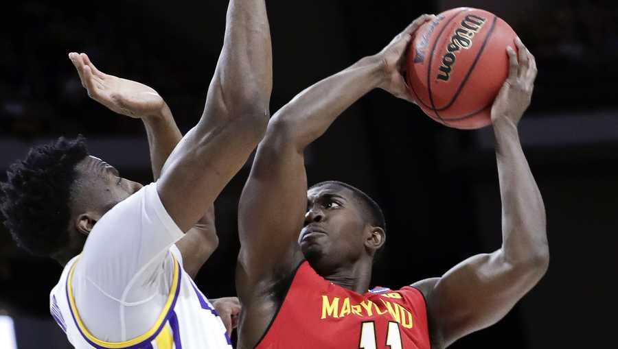 Maryland's Darryl Morsell (11) takes a shot against LSU's Kavell Bigby-Williams, left, during the first half of a second-round game in the NCAA men’s college basketball tournament in Jacksonville, Fla., Saturday, March 23, 2019. (AP Photo/John Raoux)