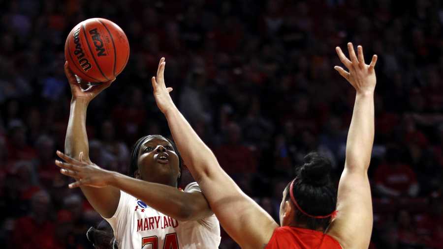 Maryland forward Brianna Fraser, left, shoots over Radford center Sydney Nunley in the second half of first-round game in the NCAA women's college basketball tournament, Saturday, March 23, 2019, in College Park, Md. Maryland won 73-51. (AP Photo/Patrick Semansky)