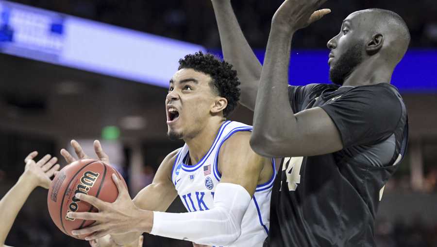 Duke guard Tre Jones (3) attempts a shot against Central Florida center Tacko Fall (24) during the first half of a second-round game in the NCAA men's college basketball tournament Sunday, March 24, 2019, in Columbia, S.C. (AP Photo/Sean Rayford)