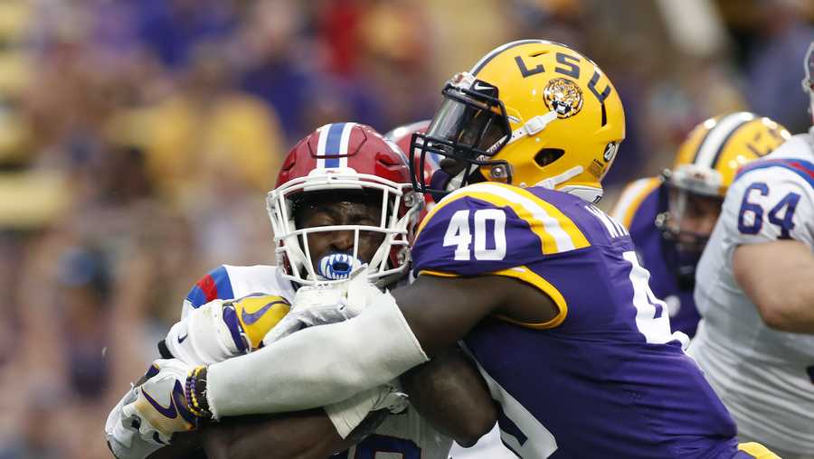 FILE - In this Sept. 22, 2018, file photo, LSU linebacker Devin White (40) tackles Louisiana Tech running back Jaqwis Dancy (23) in the first half of an NCAA college football game, in Baton Rouge, La. White is a possible pick in the 2019 NFL Draft.  (AP Photo/Tyler Kaufman, File)