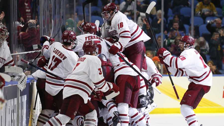 Massachusetts players celebrate a 4-3 overtime victory over Denver in the semifinals of the Frozen Four NCAA men's college hockey tournament Thursday, April 11, 2019, in Buffalo, N.Y. (AP Photo/Jeffrey T. Barnes)