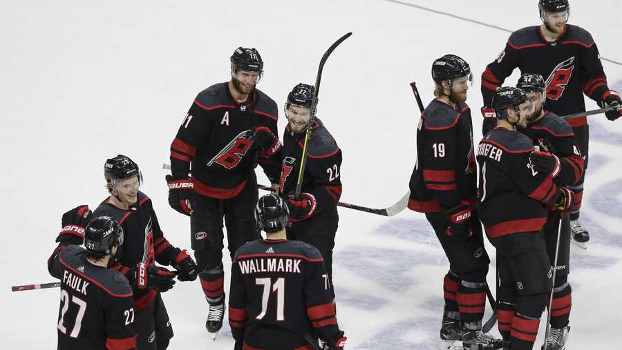 Carolina Hurricanes players celebrate following their win over the New York Islanders in Game 4 of an NHL hockey second-round playoff series in Raleigh, N.C., Friday, May 3, 2019. (AP Photo/Gerry Broome)