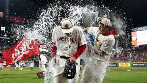 Cincinnati Reds' Nick Senzel, front, is doused byDerek Dietrich, back, after the team's baseball game against the San Francisco Giants, Saturday, May 4, 2019, in Cincinnati. The Reds won 9-2. (AP Photo/Aaron Doster)