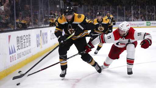 Carolina Hurricanes' Jordan Staal (11) tries to poke the puck away from Boston Bruins' David Backes, left, during the second period in Game 1 of the NHL hockey Stanley Cup Eastern Conference finals, Thursday, May 9, 2019, in Boston. (AP Photo/Charles Krupa)