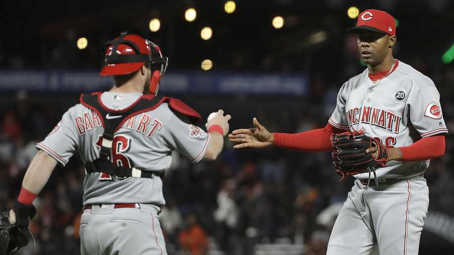 Cincinnati Reds catcher Tucker Barnhart, left, celebrates with pitcher Raisel Iglesias after the Reds defeated the San Francisco Giants 5-4 in a baseball game in San Francisco, Saturday, May 11, 2019. (AP Photo/Jeff Chiu)